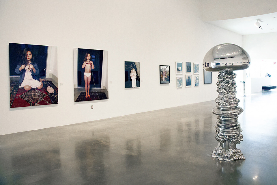installation view with tall chrome sculpture